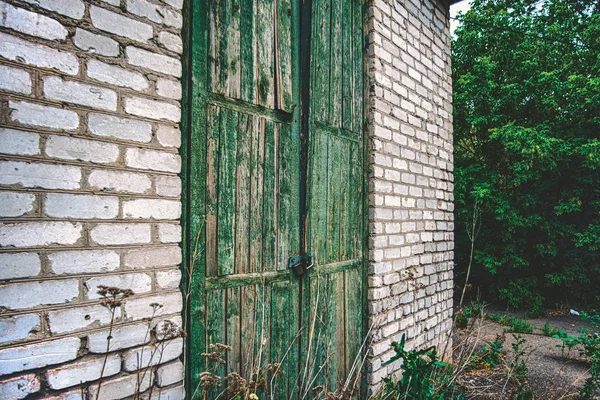 Old door in a brick wall, wide angle photo. — Stock Photo, Image