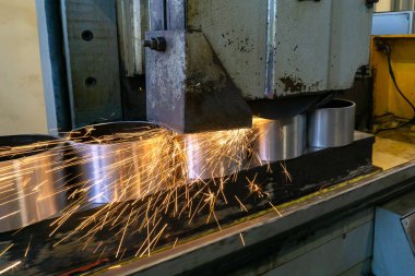 Kıvılcımlı bir makinede metalin düz taşlanması, parçaların teknolojik olarak öğütülmesi.