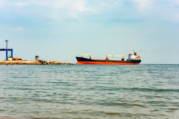 The ship enters the seaport for loading or unloading cargo.