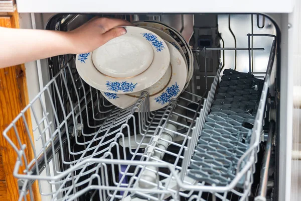 Woman Puts Dirty Plates Dishwasher — Stock Photo, Image