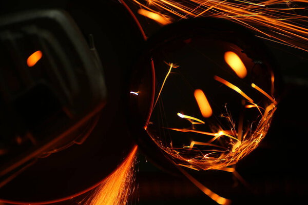 Cutting a metal pipe with angle grinder.