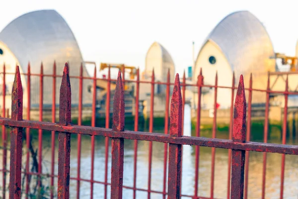 Rusty gate with Thames Barrier in the background for concept use