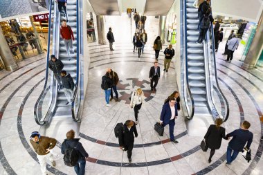 London, UK - June 25, 2018 - Cabot Place in Canary Wharf with people up and down on escalators clipart