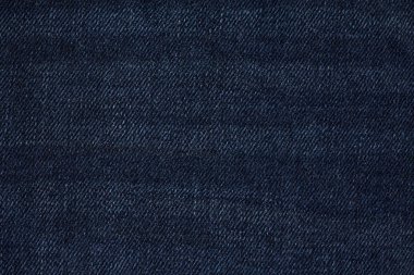 Denim kot desenli yırtık. Renkli pamuk kumaşın dokusu. Dikilmiş desenli kot pantolon. Moda pantolonu düğmesi. Kotun üzerindeki perçin ve cep. İplik ve kumaş yapısı.