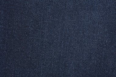 Denim kot desenli yırtık. Renkli pamuk kumaşın dokusu. Dikilmiş desenli kot pantolon. Moda pantolonu düğmesi. Kotun üzerindeki perçin ve cep. İplik ve kumaş yapısı.