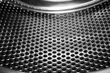 Çamaşır makinesi davul iç. Otomatik çamaşır makinesi için delikli paslanmaz çelik tambur. Siyah ve beyaz, Metalik arka plan                    