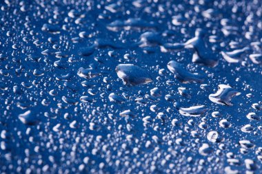 Altın arka plan üzerinde renkli su damlacıkları. Soyut sıvı spreyler