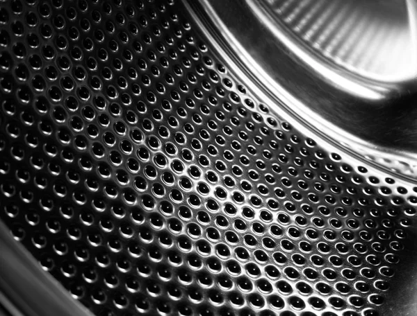 Çamaşır makinesi davul iç. Otomatik çamaşır makinesi için delikli paslanmaz çelik tambur. Siyah ve beyaz, Metalik arka plan                    