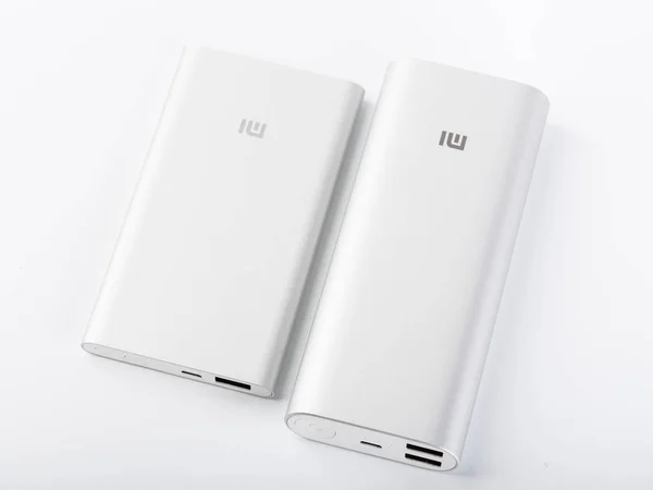 Power bank for charging mobile devices. White smart phone charger with power bank. battery bank. External battery for mobile devices.