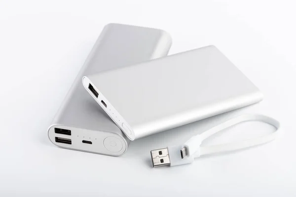 Power bank for charging mobile devices. White smart phone charger with power bank. battery bank. External battery for mobile devices.