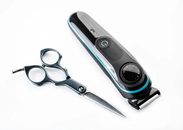 Hair trimmer and scissors isolated on the white background. Beard and hair clippers.