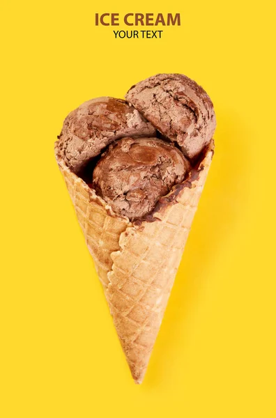 ice cream balls in a Waffle Cone on a yellow Background. ?hocolate ice cream in a waffle cone.