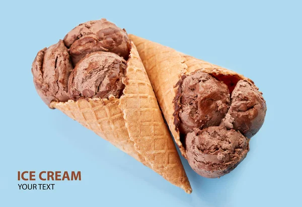 ice cream balls in a Waffle Cone on a blue Background. ?hocolate ice cream in a waffle cone.