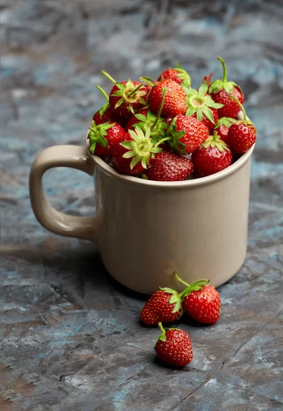 Fresh red strawberry on a dark abstract background. Summer berries. The concept of healthy eating.