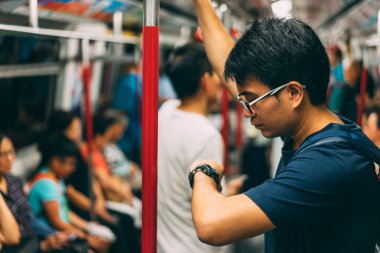 Genç adam gezgin Hongkong Metro Mtr tren ile ziyaret ve izlemek arıyorum. Toplu taşıma treni hızlı transit demiryolu sistemidir Hong Kong.