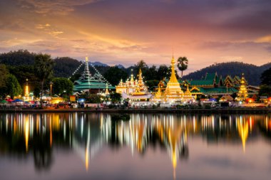 Sunset scence of Wat Jongklang temple - Wat Jongkham temple the most favourite place for tourist in Mae hong son near Chiang mai, Thailand with reflect sky in water