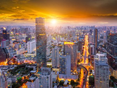 Aerial view of Bangkok skyline and skyscraper on Silom road center of business in capital. Modern city and BTS skytrain with Chao Phraya river at Bangkok Thailand on sunrise