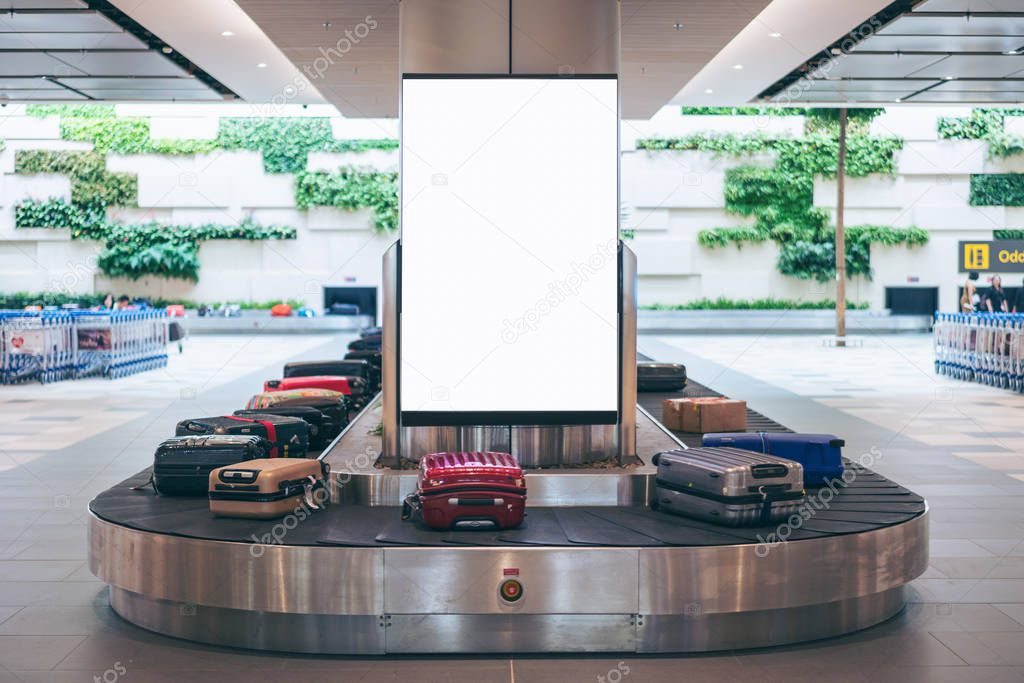 Blank advertising billboard with baggage and luggage in the international airport