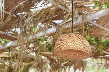 Wicker lampshade in an outdoor cafe. clipart