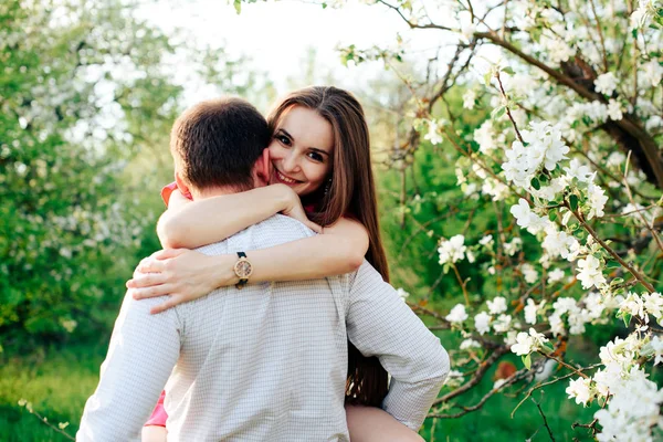 young enamored couple in the spring lush apple orchards 1