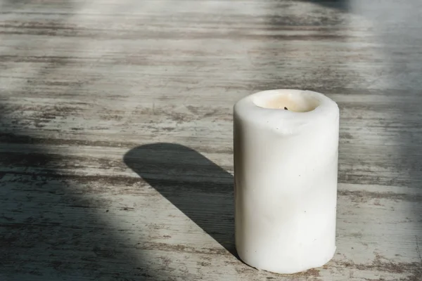 round white candle without a fire on a gray-brown background 1