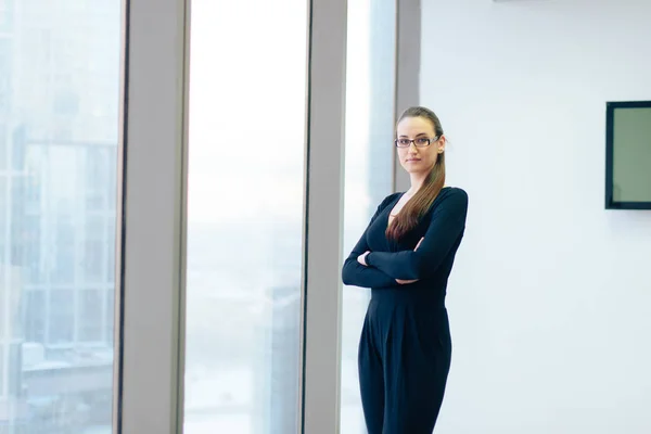 beautiful girl business lady in her office in a skyscraper