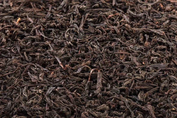Dried tea leaves. Large leaf black tea. Close-up.