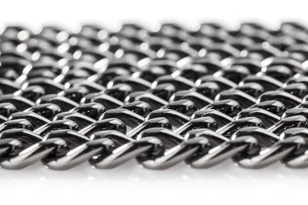 Abstract background of black decorative steel chain lying on a white background. Close-up.