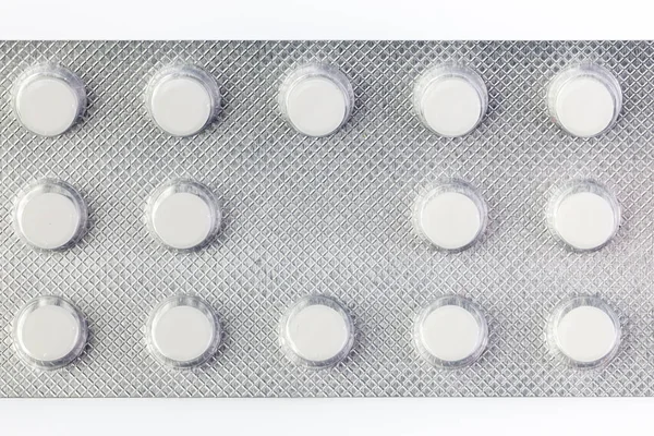 Pile of tablets in blister packaging. Pharmaceutical industry. Pharmacy products. Health care. New blister with pills isolated on a white background.