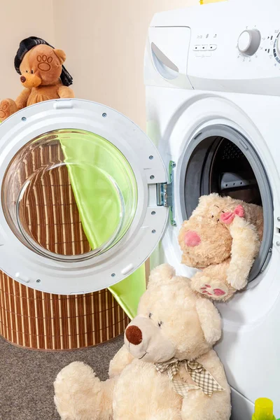 Delicate washing of soft toys in the washing machine. After washing. clean toys are located near the washing machine.