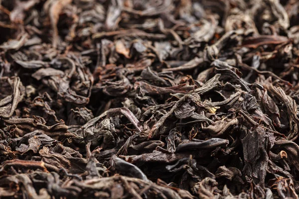 Dried tea leaves. Large leaf black tea. Close-up.
