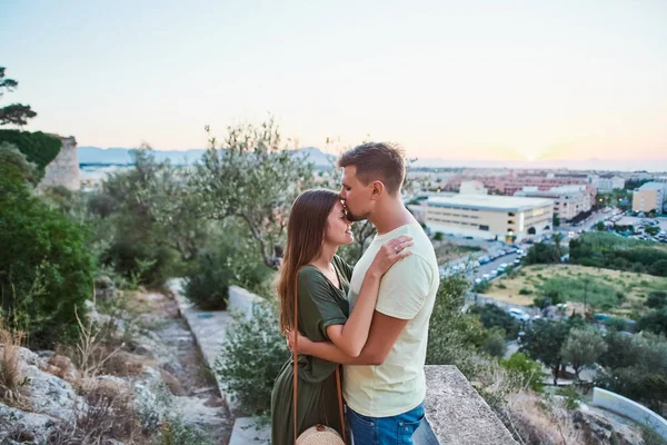 Sensual young couple in love with eyes closed with panoramic view on background.