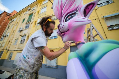 Spain Denia the 13th of March 2017.Workers install fallas dolls of polystyrene on the streets of Denia. clipart