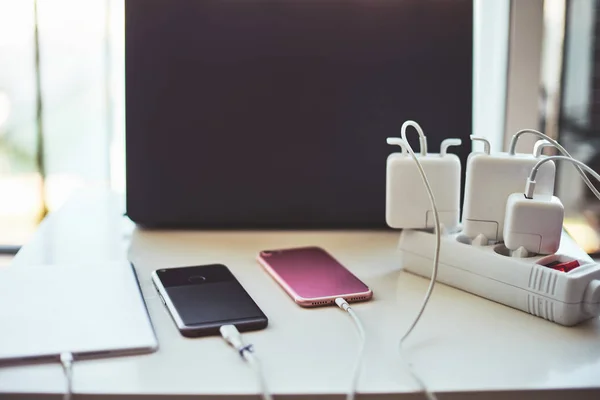 Adapter for smartphone and laptop charging on the table