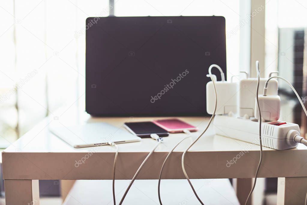 Adapter for smartphone and laptop charging on the table