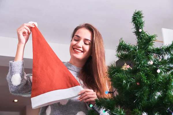 Junge Glückliche Frau Pullover Mit Weihnachtsmütze Beim Schmücken Des Weihnachtsbaums — Stockfoto
