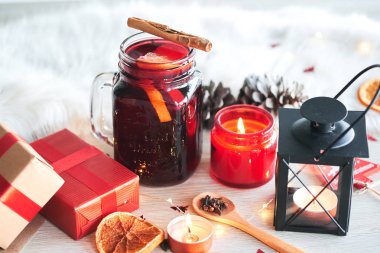 Noel kompozisyon ile sıcak bir fincan meyve, mumlar, hediyeler ve türler tablo ile şarap mulled. Tatil ruh hali.