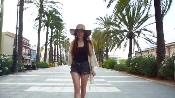 Pretty young smiling woman tourist walking and enjoying sunny summer day — Stock Video