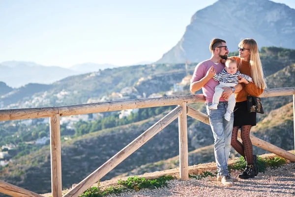 Glückliche junge Familie mit kleinem netten Jungen genießt den sonnigen Tag — Stockfoto