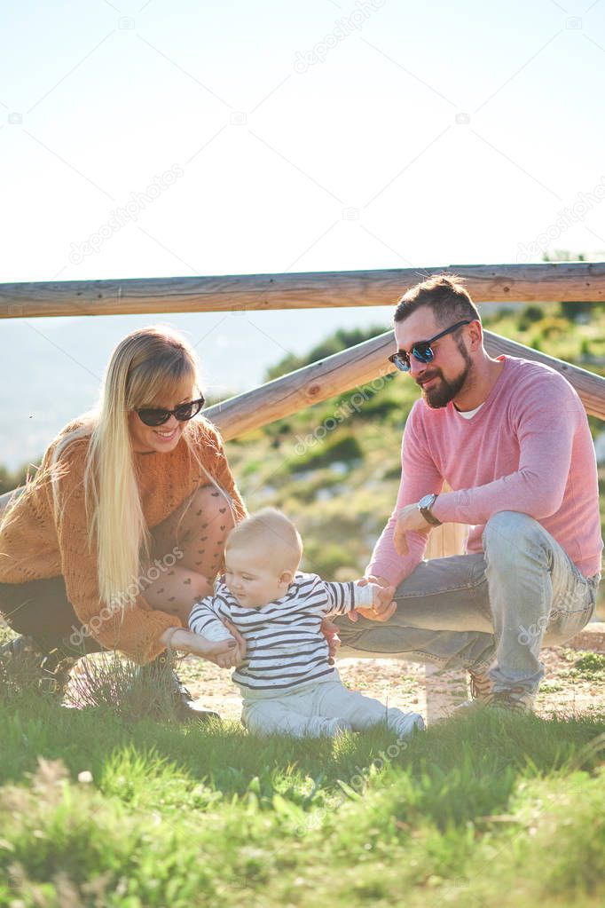 Portrait of happy young family with little cute boy enjoying the sunny day
