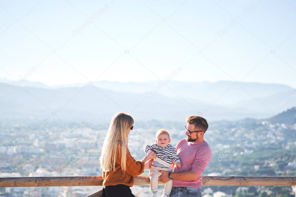 Happy young family with little cute boy enjoying the sunny day