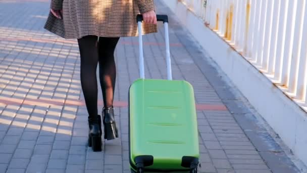 Yeşil Bavul Ile Yürüyen Yüksek Topuklu Genç Kadını Geri Görünümü — Stok video