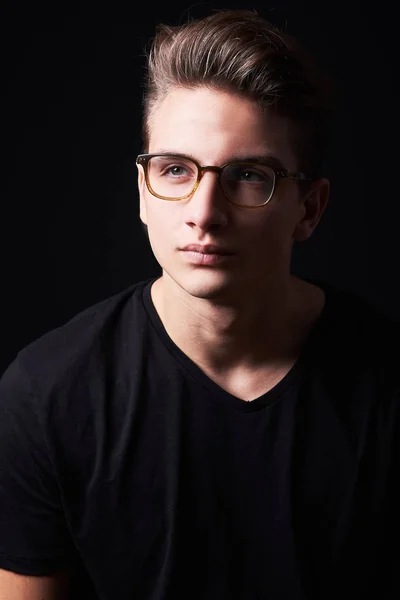 Portrait of elegant young handsome man isolated on black background