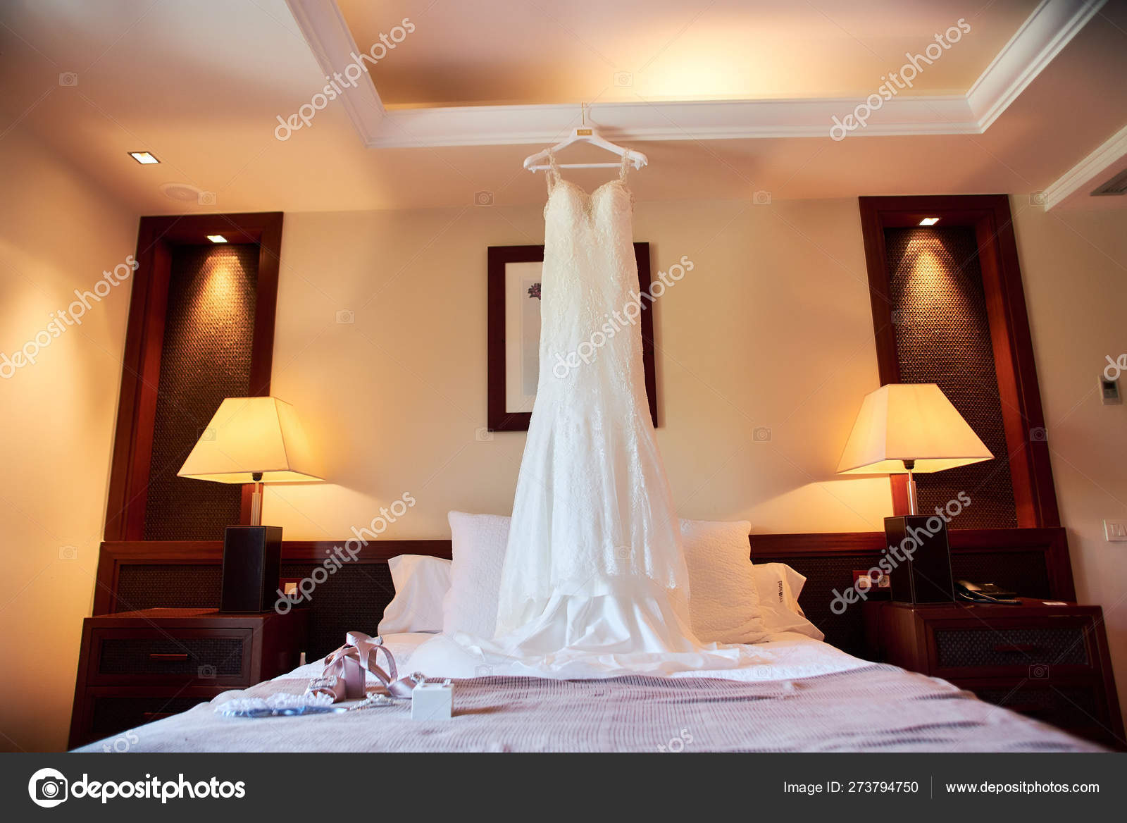 Wedding Dress Hanging On The Ceiling In A Luxury Hotel Room