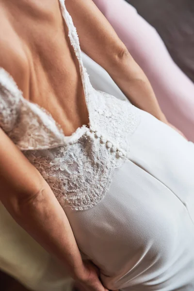 Back view of a bride in an elegant wedding dress.