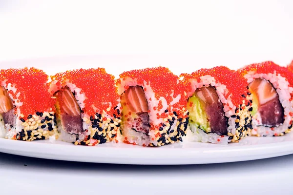 Uramaki sushi rolls with red caviar, salmon and avocado isolated — Stock Photo, Image