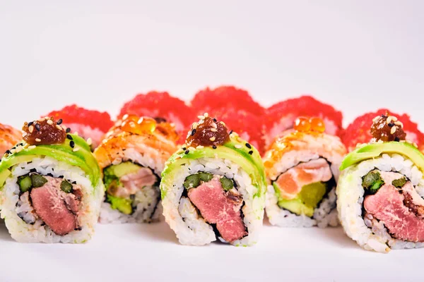 Primer plano de los rollos de sushi uramaki con caviar rojo, salmón y aguacate — Foto de Stock