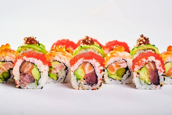 Close-up of uramaki sushi rolls with red caviar, salmon and avocado — Stock Photo, Image