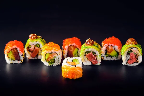 Primer plano de los rollos de sushi uramaki con caviar rojo, salmón y aguacate — Foto de Stock