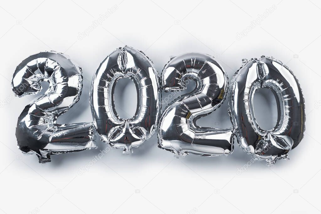 Silver colored 2020 New Year balloons isolated on white. Holidays and Christmas concept. Top view. Copy space